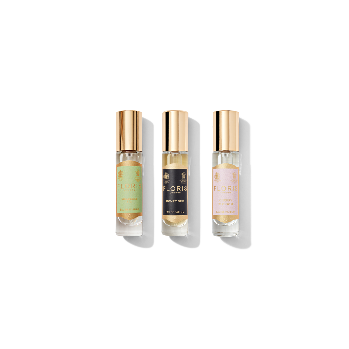 In the Holiday Cracker Collection by Floris London EU, three perfume bottles adorned with gold caps glisten like hidden treasures. The labels display: Floris Tuberose (green), Floris Honey Oud Intense (black), and Floris A Rose For... (pink). Exquisite additions to your celebrations, these enchanting scents are as delightful as cracking open a holiday cracker.