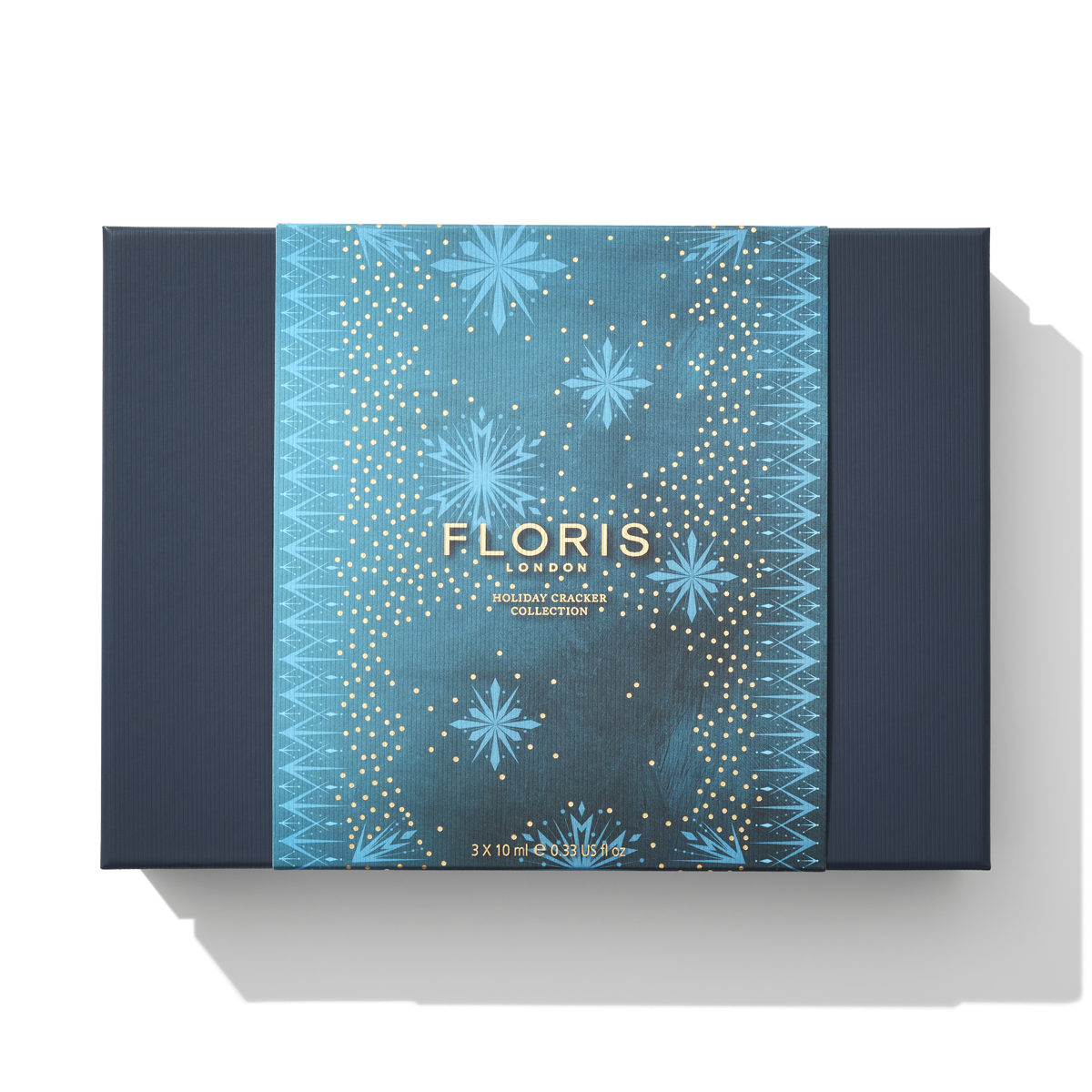A rectangular, blue box from Floris London EU with a holiday cracker collection theme. The box features blue and gold star designs and the text "Floris London EU Holiday Cracker Collection," celebrating a cherished British tradition.