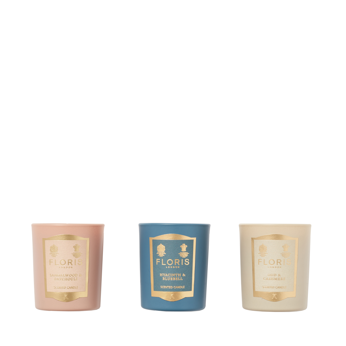 The Floris London EU Miniature Candle Collection features three scented candles in pink, blue, and cream holders, arranged against a white background.