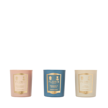 The Floris London EU Miniature Candle Collection features three scented candles in pink, blue, and cream holders, arranged against a white background.