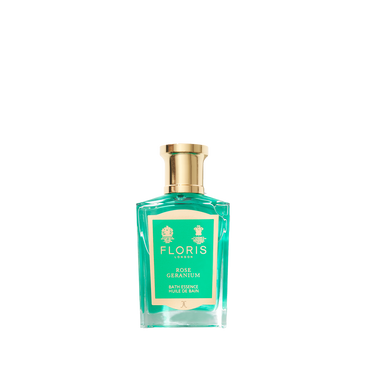 A green glass bottle of Floris London Rose Geranium - Bath Essence with a gold cap and green label, shown on a white background.