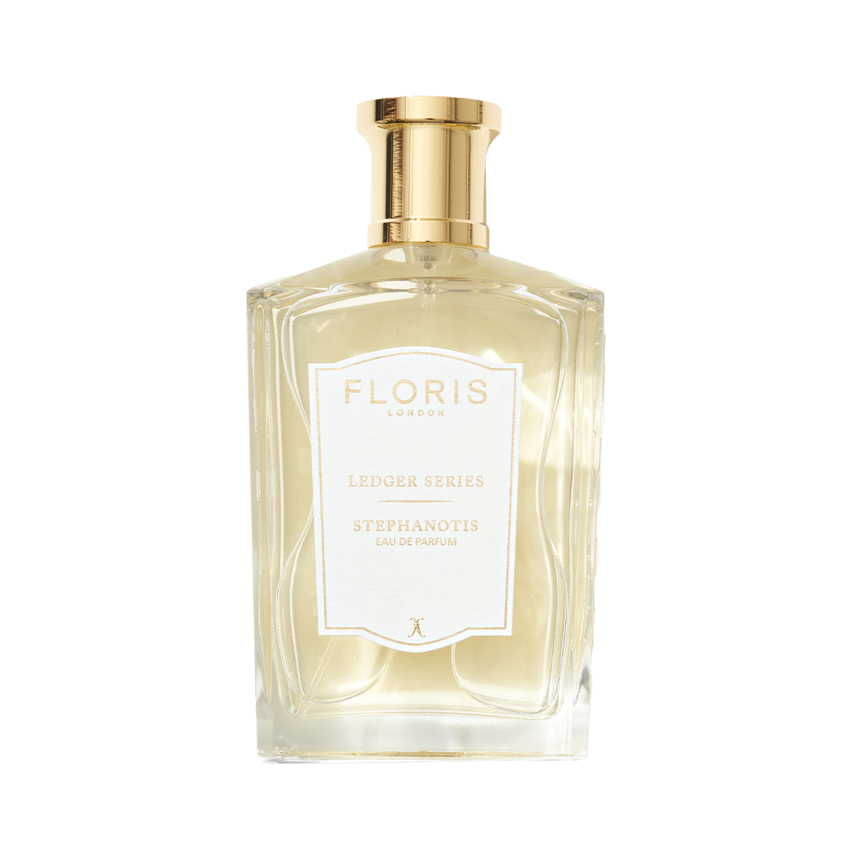 A clear glass bottle of Floris London EU Stephanotis perfume with a gold cap, white label, and light yellow floral fragrance inside.