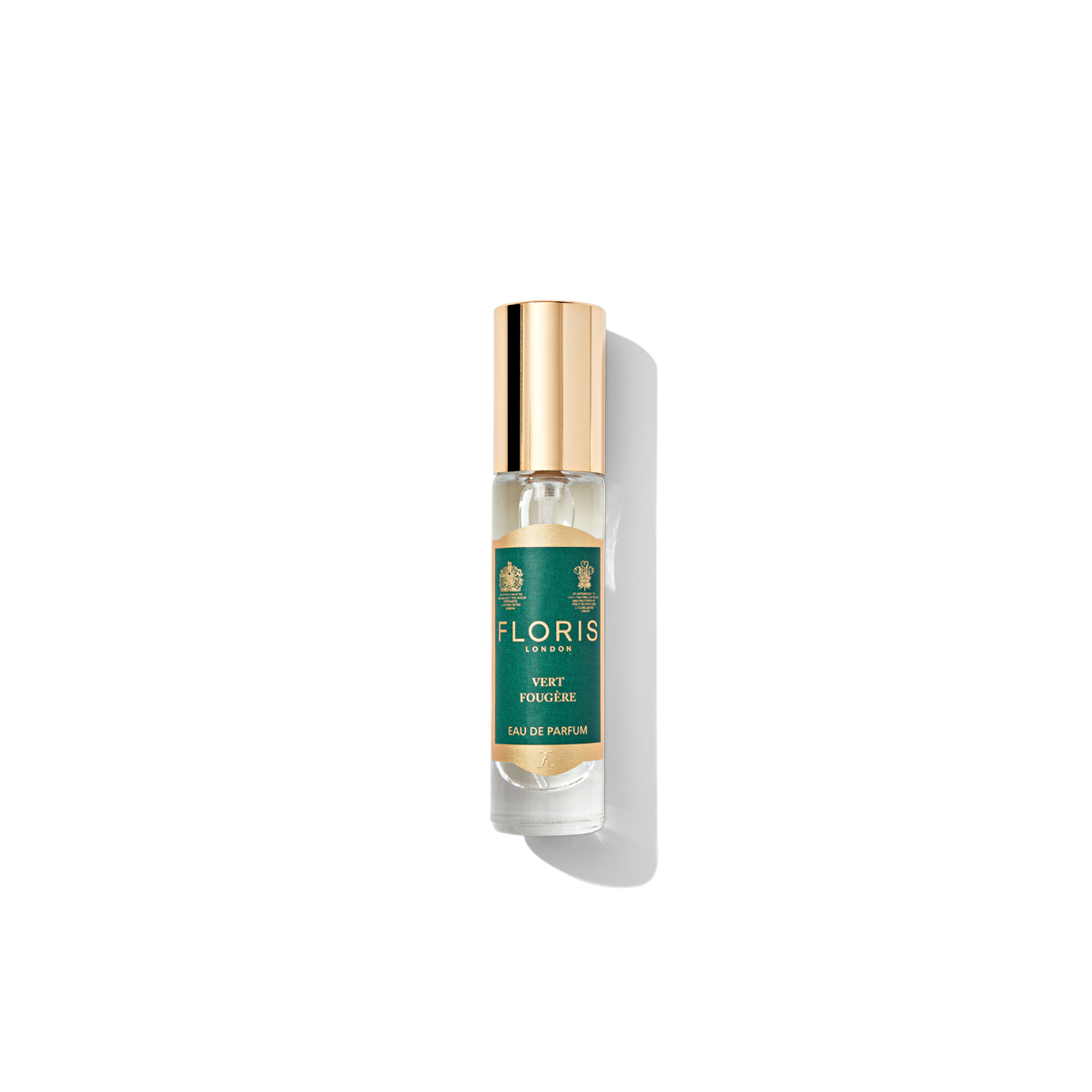 A small glass bottle of Floris London's Vert Fougère Eau de Parfum with a gold cap and green label, exuding a moody fragrance characteristic of a classic fougère.