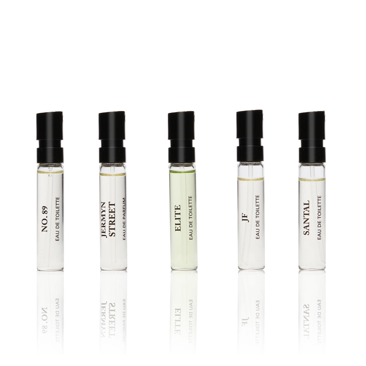 Five mini glass vials with black writing containing Jermyn Street Collection