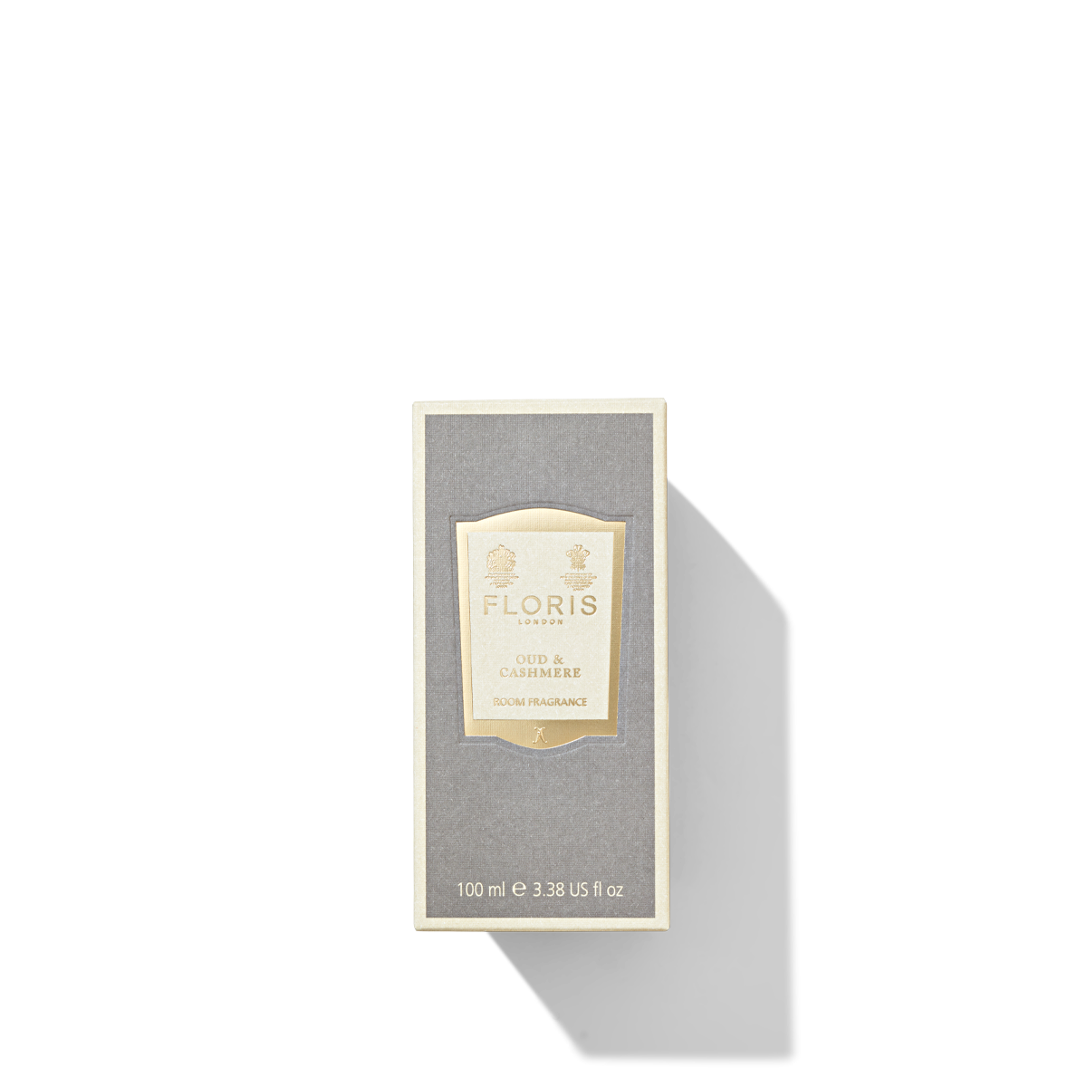 Medium grey box with a cream and gold label containing the Oud & Cashmere Room Fragrance.