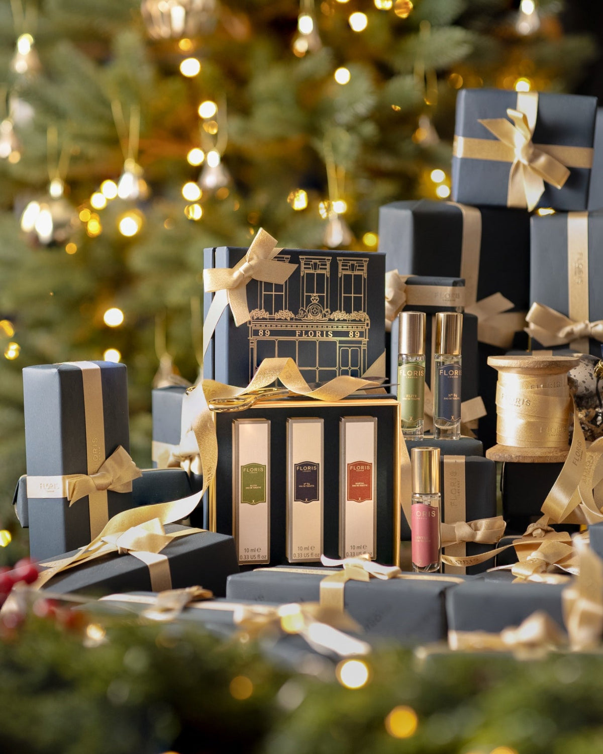 A bottle of Rose Geranium bath essence, surrounded by Floris gift boxes