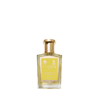 A clear glass bottle of Floris London Bergamotto di Positano Eau de Parfum with a gold cap and yellow label offers a fresh Mediterranean bergamot scent.