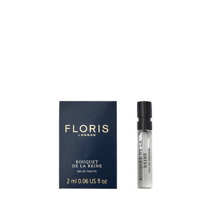 A 2ml spray vial of Floris London’s Bouquet de La Reine Eau de Toilette sits beside its dark blue box with gold text, evoking regal elegance.