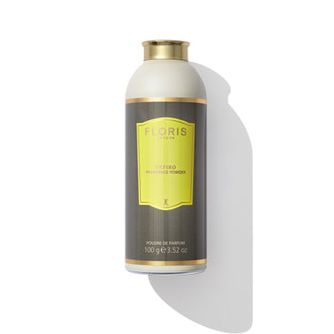 A 100g bottle of Cefiro - Fragrance Powder by Floris London EU, featuring a unisex citrus floral scent, adorned with a yellow and gray label highlighted by gold accents, and capped with a gold top, set against a white background.
