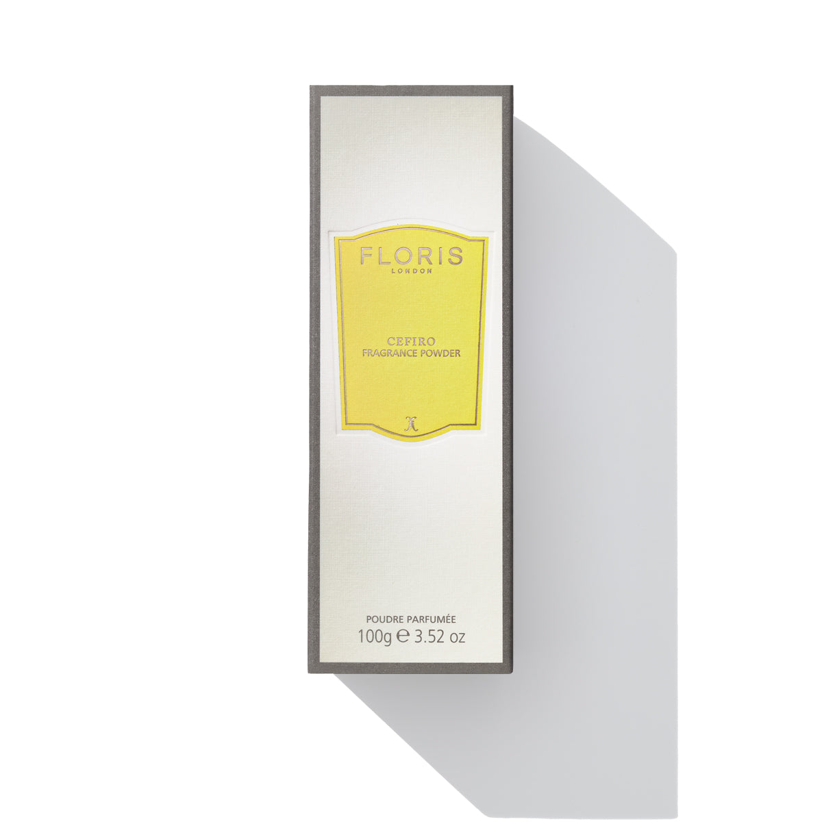 A rectangular box of Cefiro - Fragrance Powder by Floris London EU, boasting a unisex citrus floral scent, is centered on a white background. The predominantly white packaging features yellow and black accents and contains 100g of powder.