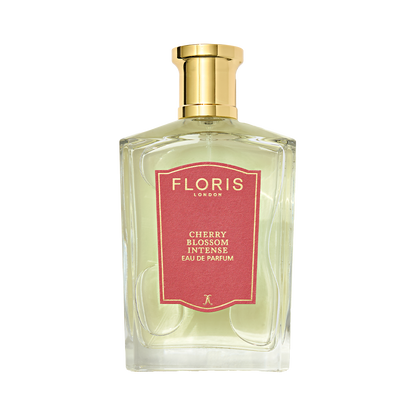 A clear glass bottle of Floris London Cherry Blossom Intense - Eau de Parfum with a gold cap and red label, set against a plain background.