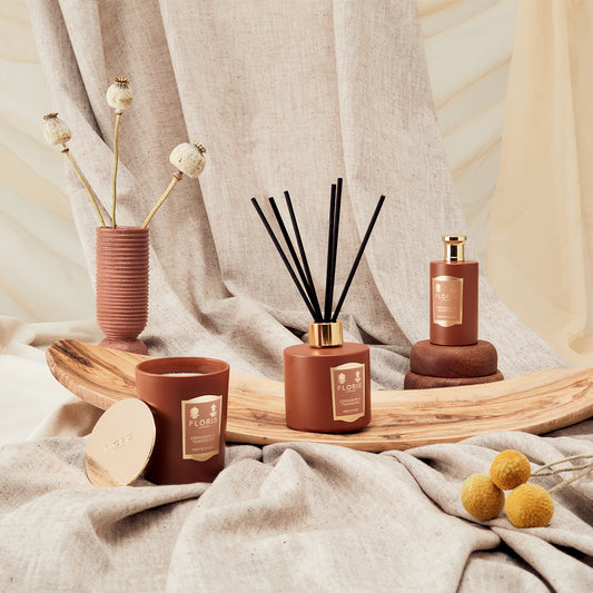 The Floris London Cinnamon & Tangerine Reed Diffuser fills a neutral space with vibrant fragrance, complemented by dried florals and wooden accents.