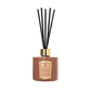 The Floris London "Cinnamon & Tangerine" reed diffuser features black sticks, a gold cap, and a rich scent, set against a plain white background.