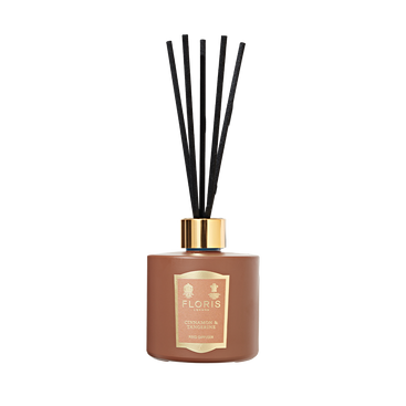 The Floris London "Cinnamon & Tangerine" reed diffuser features black sticks, a gold cap, and a rich scent, set against a plain white background.