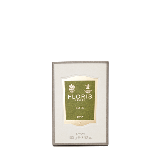 A 100g box of Floris London EU Elite Soap, with a green and gold label and woody notes, is displayed against a plain white background.