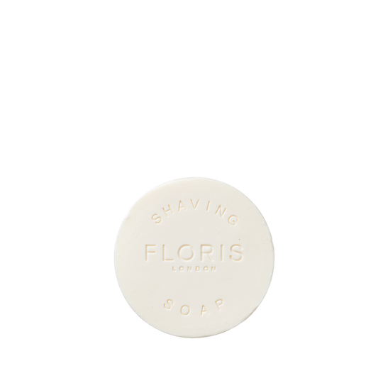 A round, white Floris London EU Elite - Shaving Soap Refill embossed with "SHAVING FLORIS LONDON SOAP," shown on a plain white background.