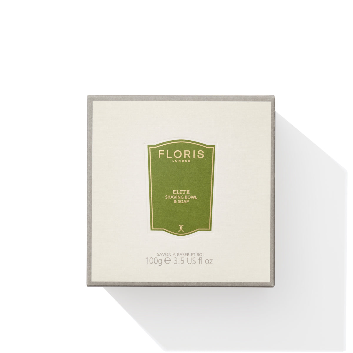 A box of Elite - Shaving Soap & Bowl by Floris London, featuring a green label and enriched with shea butter, contains 100g or 3.5 US fl oz of triple-milled shaving soap, displayed against a light background.