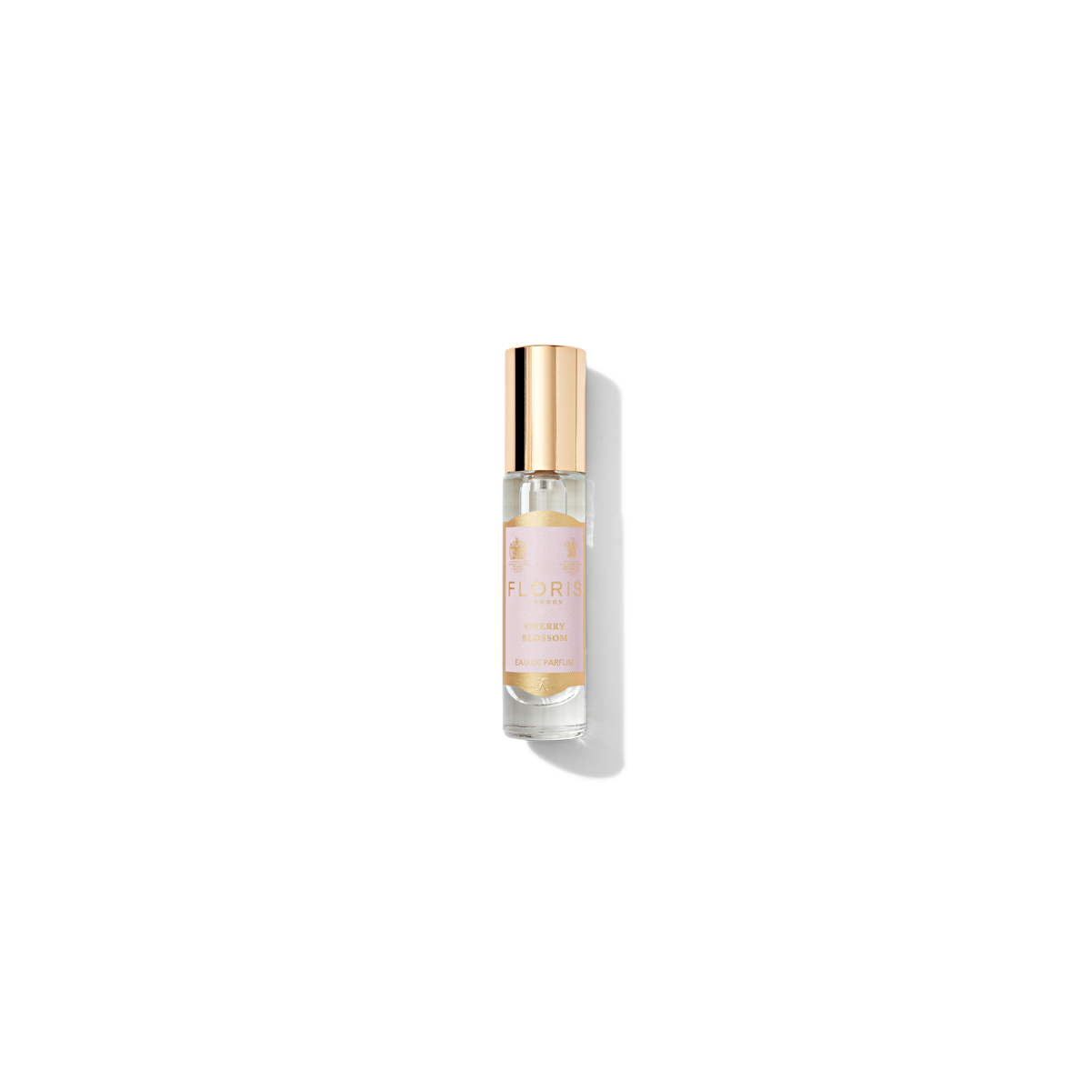 A small glass bottle of Floris London EU Cherry Blossom Holiday Cracker perfume with a gold cap and a light-colored label, reminiscent of a festive holiday cracker. The bottle displays the name and details of the fragrance, perfect for celebrating the holiday season with a touch of British tradition.