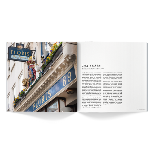 An open coffee table book reveals a photo of a building with a "Floris Perfumes" sign and on the right, a page of text titled "294 YEARS." This image is part of the Floris London EU 2024|25 Catalogue, celebrating their legacy in crafting exquisite fragrances.