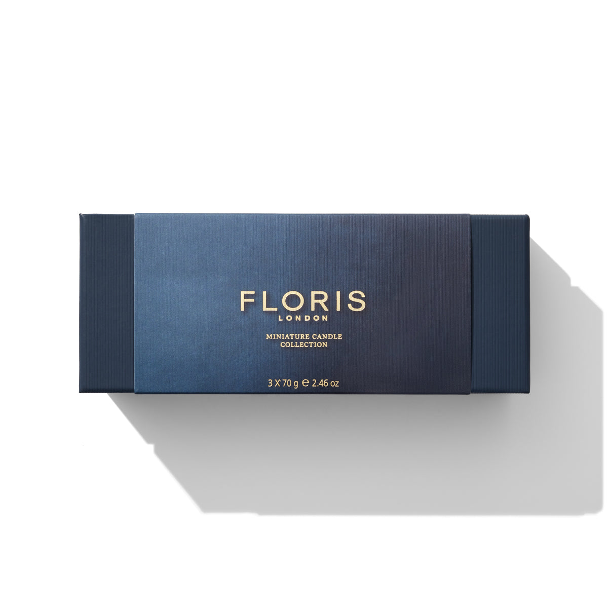 A rectangular blue box labeled "Floris London EU Miniature Candle Collection" houses three beautifully scented candles, each weighing 70g, with a total weight of 2.46 oz.