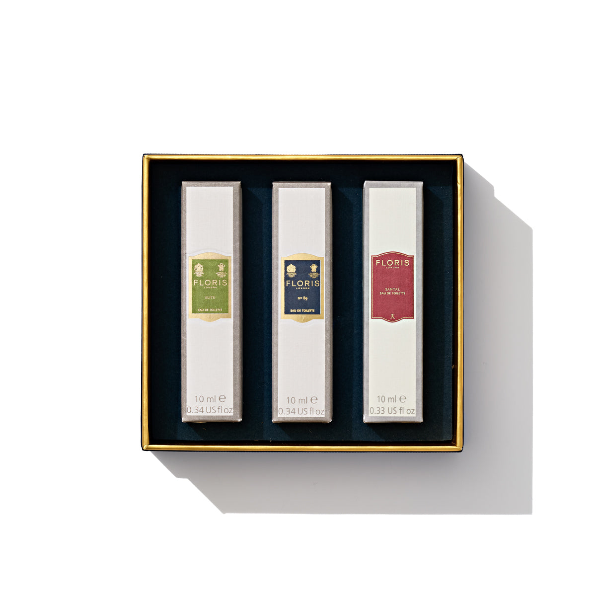 A festive gift set of British men's fragrances, Perfumer's Trilogy: For Him by Floris London EU, comes elegantly displayed in a white box with colorful accents.