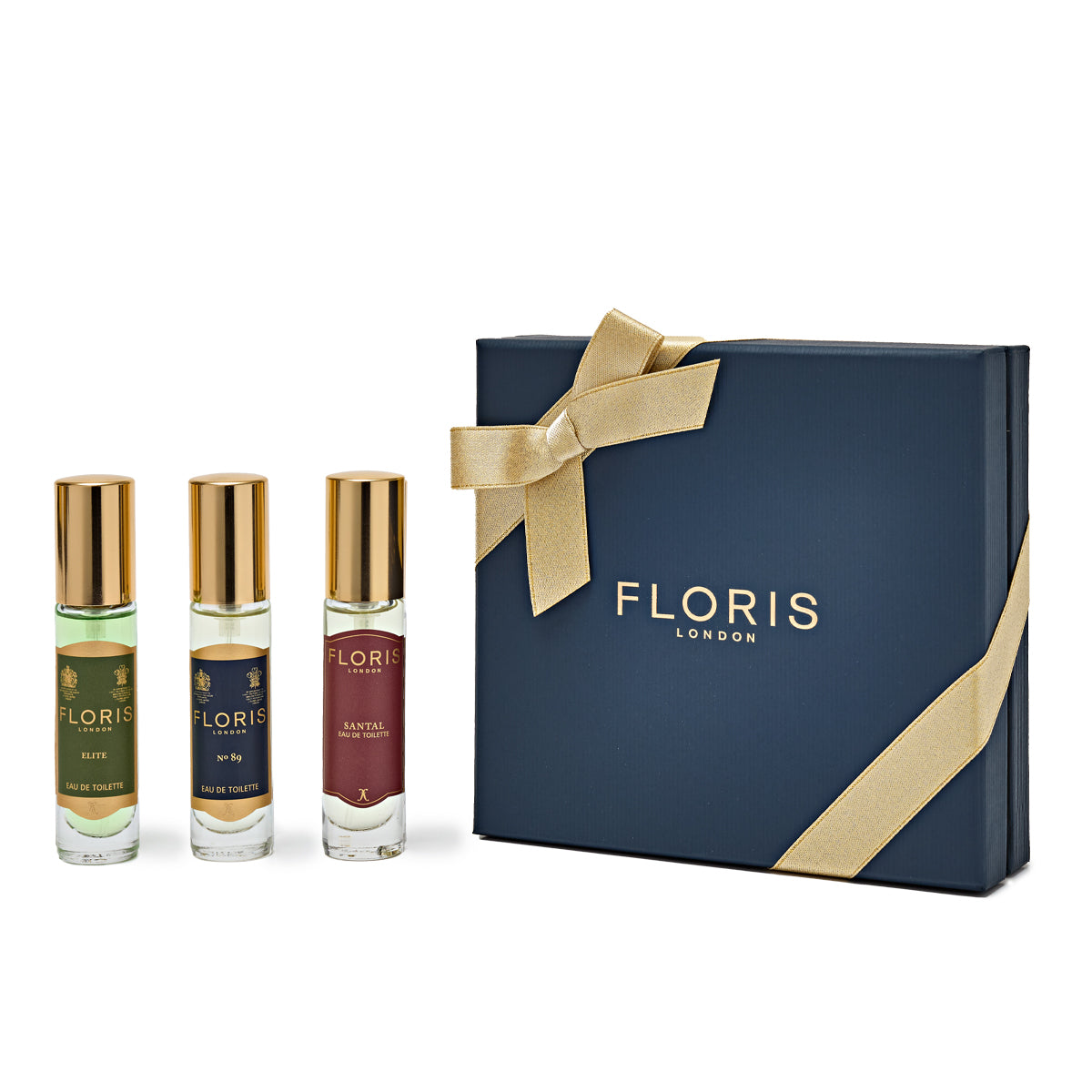A festive Floris London EU gift box in navy with a gold bow, featuring the Perfumer's Trilogy: For Him, which includes "Elite," "No. 89," and "Santal.