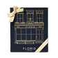 Sweet Lux | Honey Oud Duo by Floris London EU in a navy blue gift box with gold building illustration, gold logo, and gold ribbon bow on top left.
