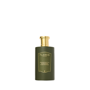 The Floris London Grapefruit & Rosemary Room Fragrance, in a green bottle with a gold pump, adds freshness against a plain white background.