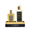 Floris London UK's Sweet Lux | Honey Oud Duo, featuring Eau de Parfum and Body Moisturiser, comes in luxe black and gold packaging on a matching tray.