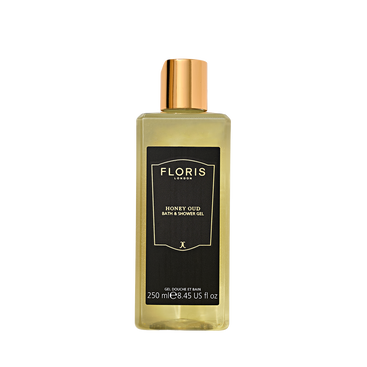 A clear 250ml Floris London UK Honey Oud Bath & Shower Gel with oud oil, gold cap, and black label holds luxurious bath gel.