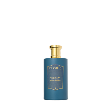 A blue bottle of Floris London Hyacinth & Bluebell Room Fragrance with a gold cap captures green floral spring notes, shown on a white background.