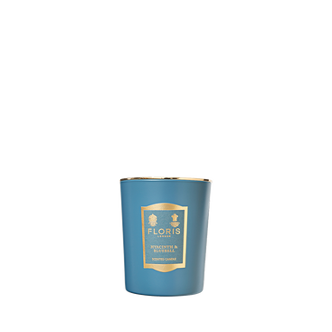 The Floris London Hyacinth & Bluebell Candle is hand poured, features a green floral scent, and comes in a glass holder with a gold label.