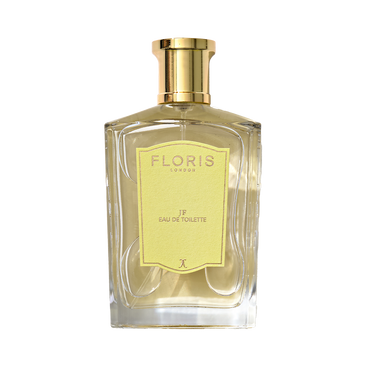 A clear glass bottle of Floris London JF - Eau de Toilette, a citrus woody men’s scent, with a gold cap and yellow label shown against a plain background.