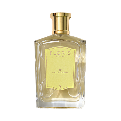 A clear glass bottle of Floris London JF - Eau de Toilette, a citrus woody men’s scent, with a gold cap and yellow label shown against a plain background.
