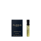 A 2ml Leather Oud - Eau de Parfum sample vial by Floris London sits beside its dark blue box, both with gold text, exuding oud oil elegance.