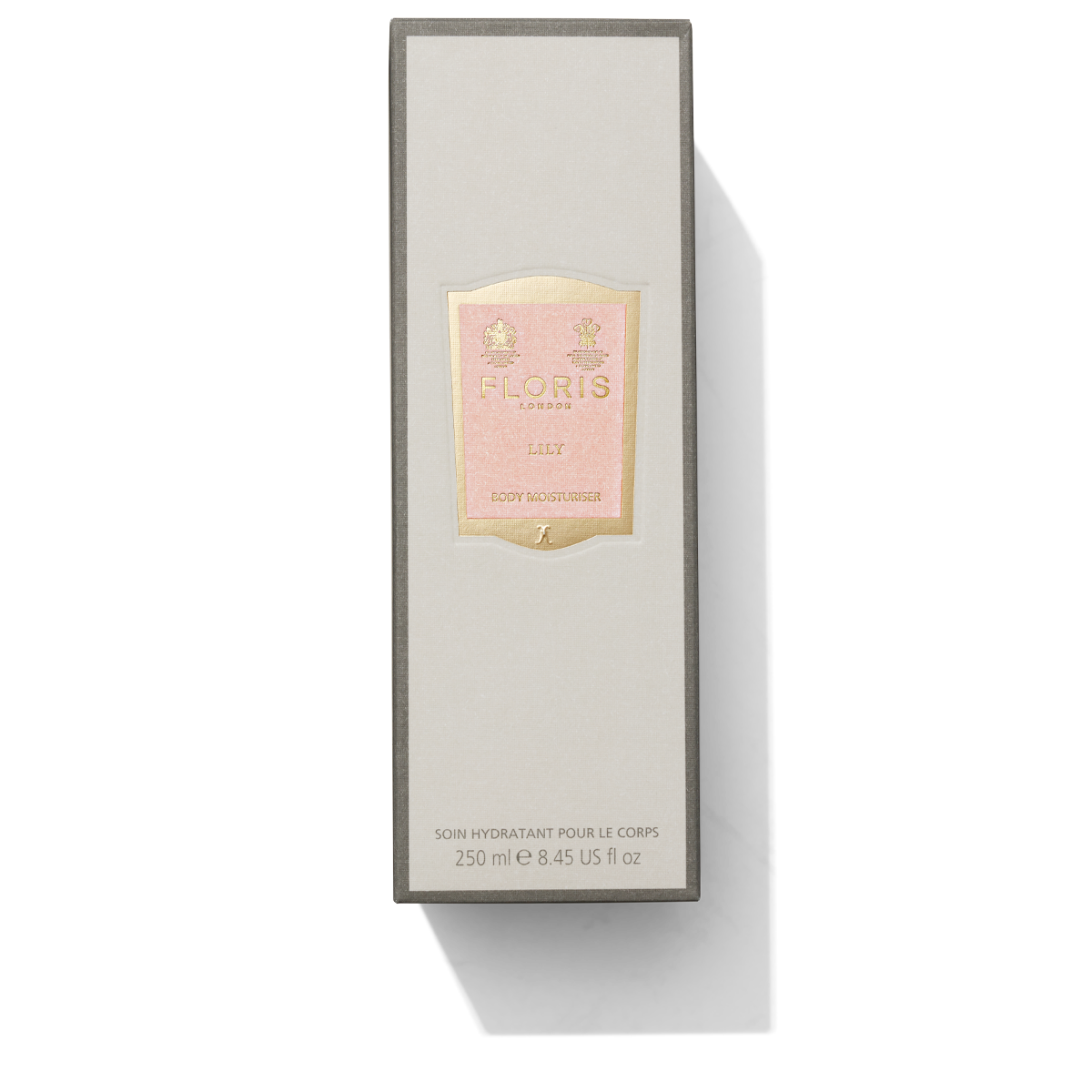 Tall grey box with light pink and gold label containing Lily Body Moisturiser 