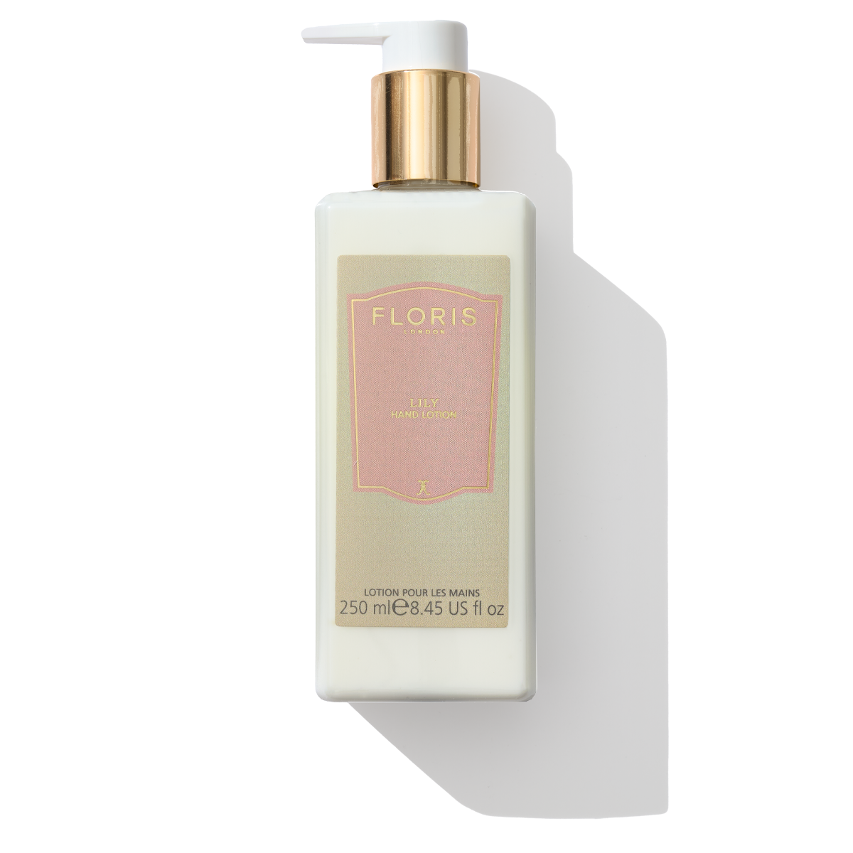 A rectangular white bottle with a gold pump dispenser, labeled "Floris London EU" and containing "Lily - Luxury Hand Lotion" in 250 ml (8.45 fl oz), formulated to soothe dry skin.