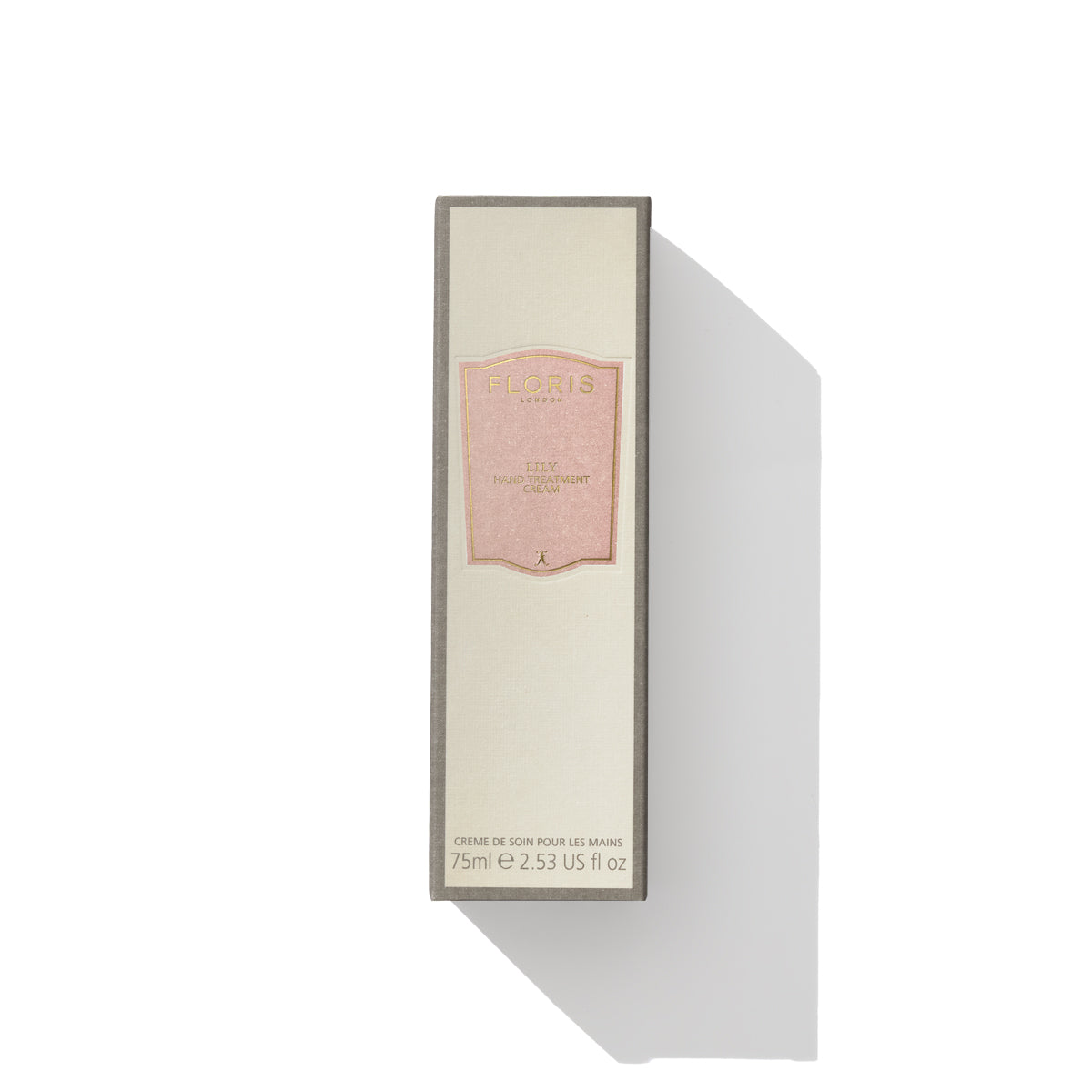 A rectangular box of luxurious Floris London EU's Lily - Hand Treatment Cream, adorned with pink labeling and containing 75 ml (2.53 US fl oz) of product. The beige packaging with a gray border makes it one of the best hand creams for very dry hands.