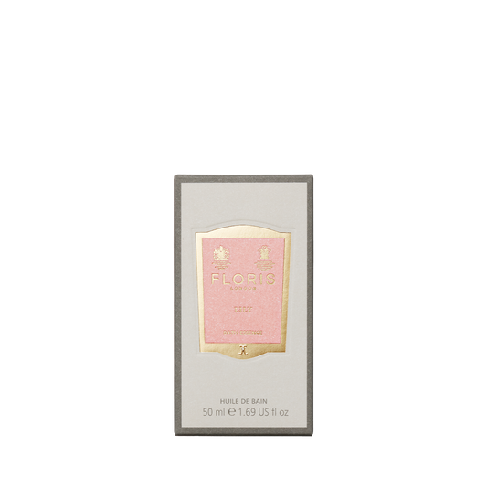A rectangular box of Floris London EU Lily Bath Essence, 50ml, with a pink and gold label and floral green scent, shown on a plain white background.