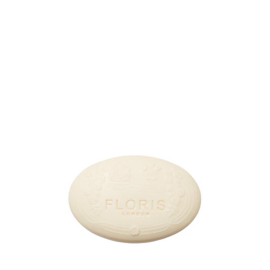 Oval-shaped white Lily - Luxury Soap by Floris London, embossed with the brand name and decorative patterns on its vegetable base.