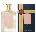 A Floris London UK Malmaison Encore fragrance bottle and its dark blue box, both featuring pink labels with gold lettering and a wax seal on the box ribbon.