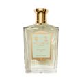 Clear glass perfume bottle with gold cap, labeled "Mulberry Fig - Eau de Parfum" by Floris London, exuding a floral amber fragrance.