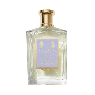 A clear glass bottle of Floris London Night Scented Jasmine Eau de Toilette features a gold cap and light purple and gold label, hinting at a seductive scent.