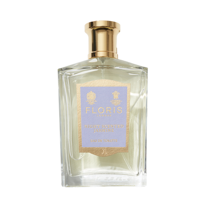 A clear glass bottle of Floris London Night Scented Jasmine Eau de Toilette features a gold cap and light purple and gold label, hinting at a seductive scent.