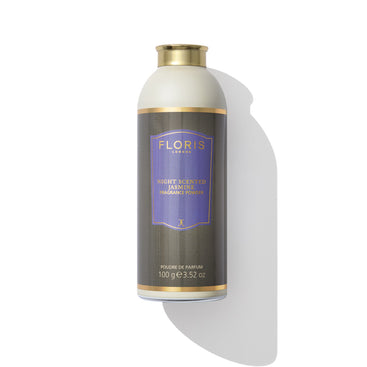 A cylindrical container labeled "Floris London EU Night Scented Jasmine - Fragrance Powder" with a gold cap, containing 100g (3.52 oz) of product, stands against a white background with a shadow.