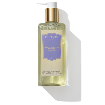 A bottle of Floris London EU Night Scented Jasmine Hand Wash, featuring a gold pump and purple label, infused with coconut and olive-derived ingredients, containing 250 ml (8.45 US fl oz) of product.