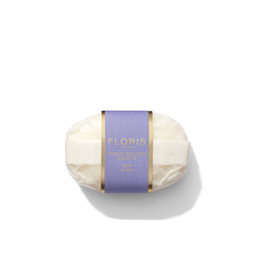 A wrapped bar of soap with a purple and gold label reading "Floris London EU, Night Scented Jasmine Soap." The packaging is cream-colored, and the soap is oval-shaped.