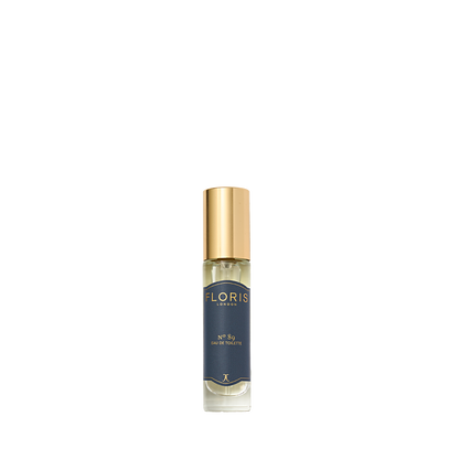 A small glass bottle of Floris London No. 89 Eau de Toilette, featuring a gold cap and dark blue label, is displayed against a light background.