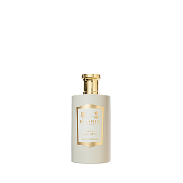A white Floris London Oud & Cashmere - Room Fragrance bottle with a gold cap and label, shown against a plain white background.
