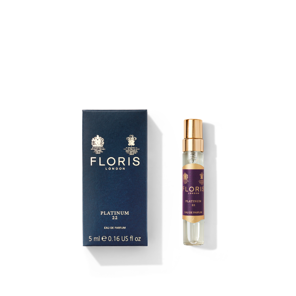 The perfume packaging includes a navy blue box from Floris London, marked with "Platinum 22 - Eau de Parfum 5ml," as well as a transparent spray bottle featuring a gold cap. This luxurious fragrance combines aromatic notes with vetiver undertones, encapsulated in style and elegance.